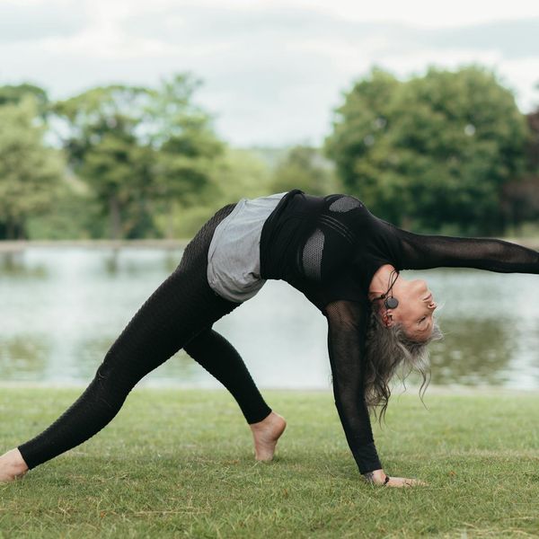 Woman performing a yoga stretch, radiating energy and wellness.